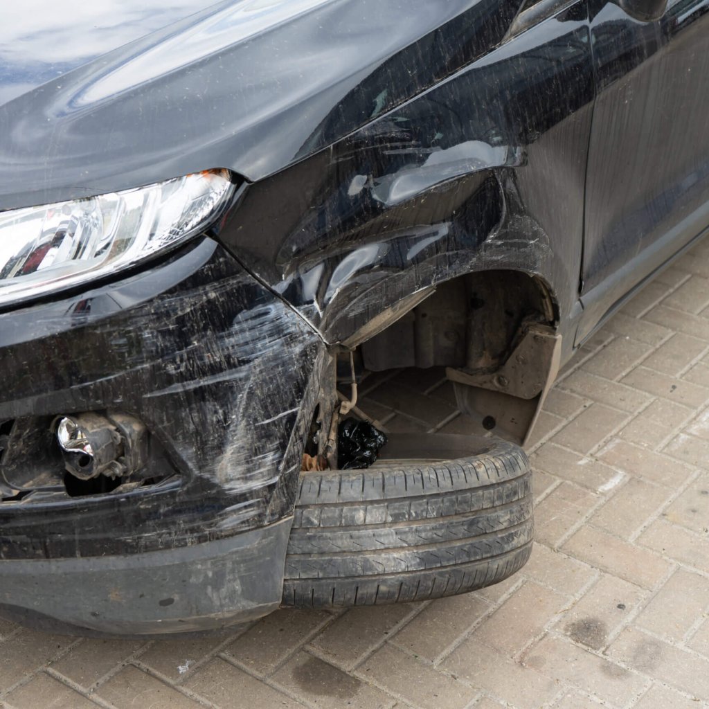 Damage to the front wheel and bumper in an accident